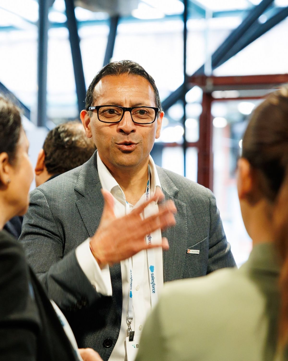 A senior leader in conversation with two colleagues